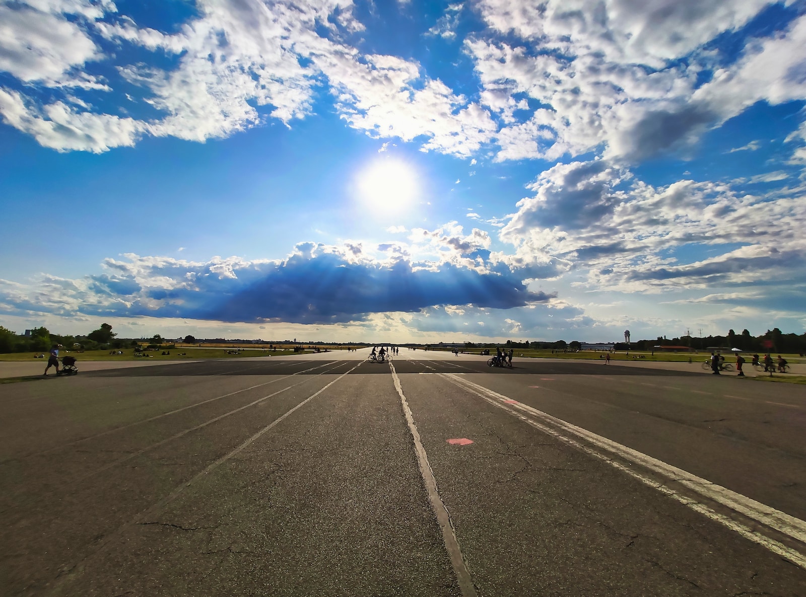 a road with a blue sky and clouds